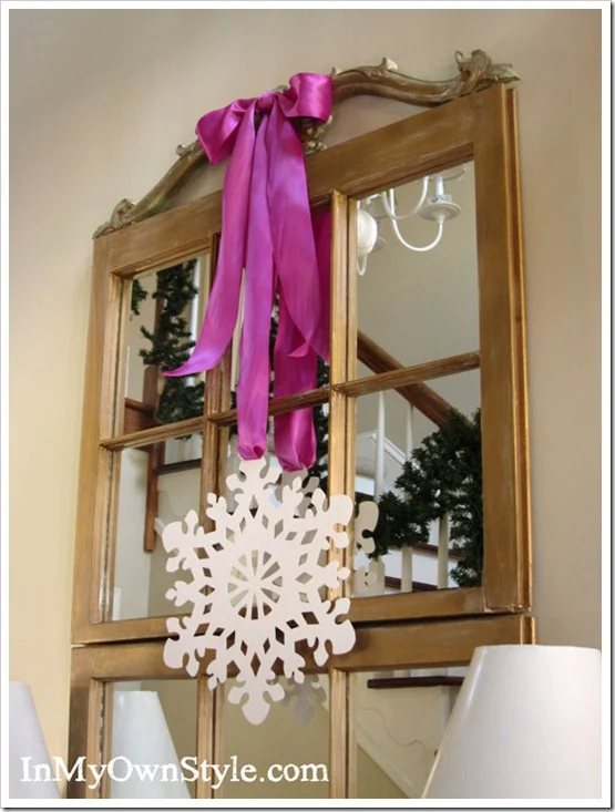 pink/purple satin ribbon bow on wall mirror