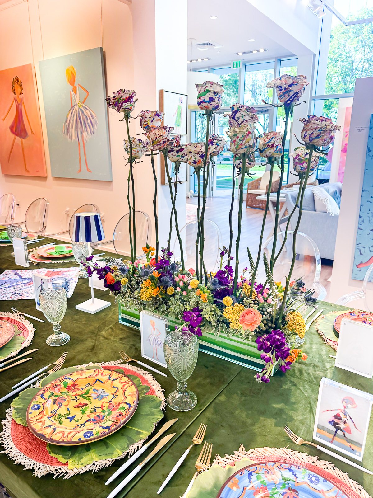 Colorful table setting with spattered painted white tulip centerpiece.