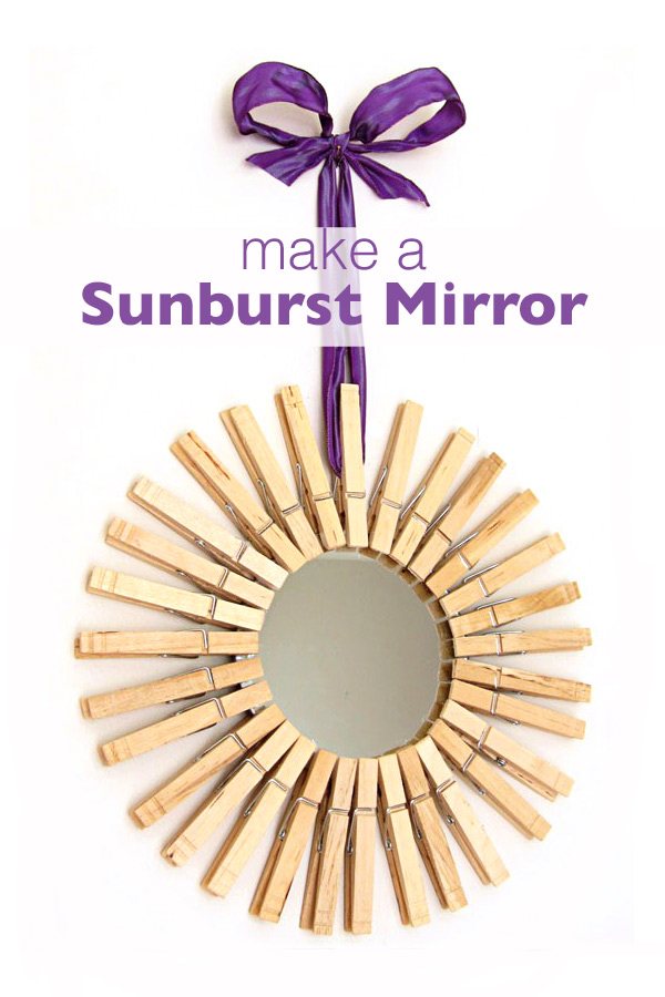Mirror framed in clothespins and hung with purple ribbon