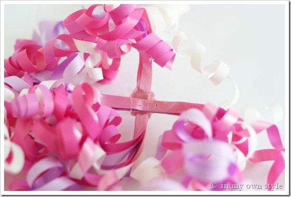 Showing where to place candle holder under ribbon.