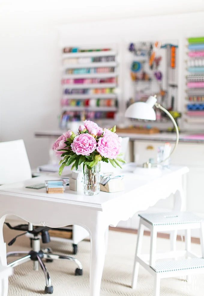 craft room with white desk and peonies