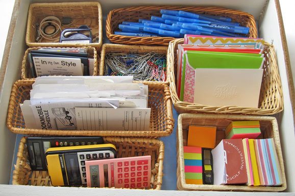 Desk-drawer-organizing-tips showing small baskets in a drawer.