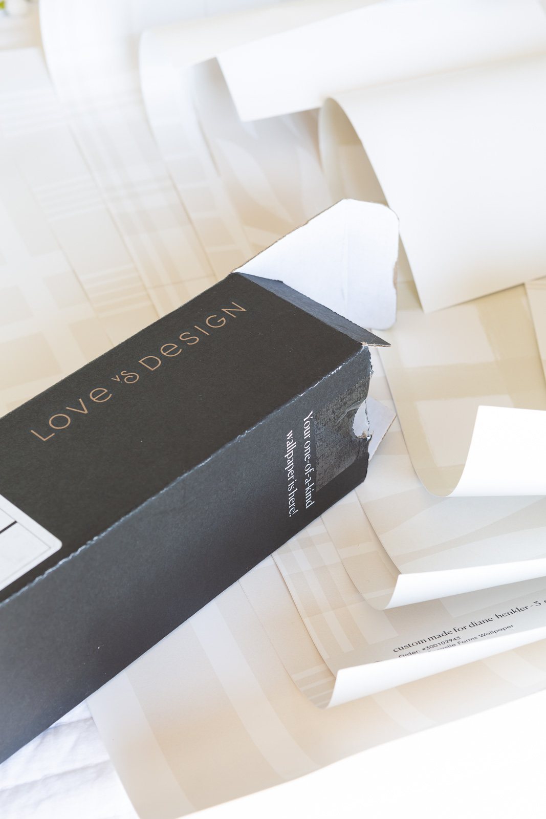 Opening box of customized wallpaper from Love & Design