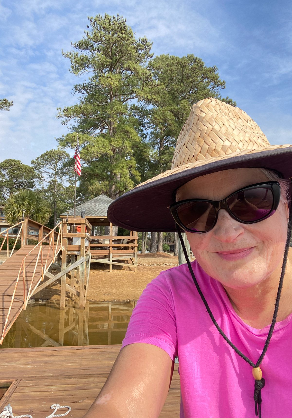 Diane Oducu with hat on dock