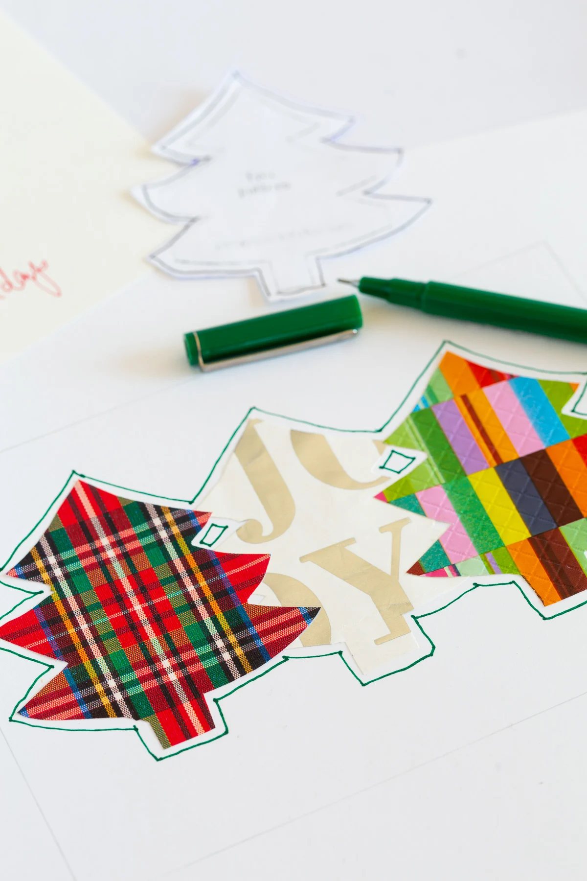 outline the cutout gift wrap trees on card.
