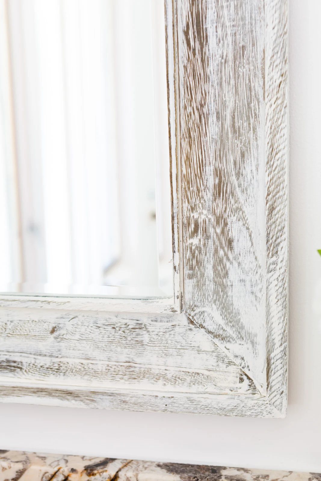 close up of Vintage Wood plaster on a rough wood surface mirror frame.