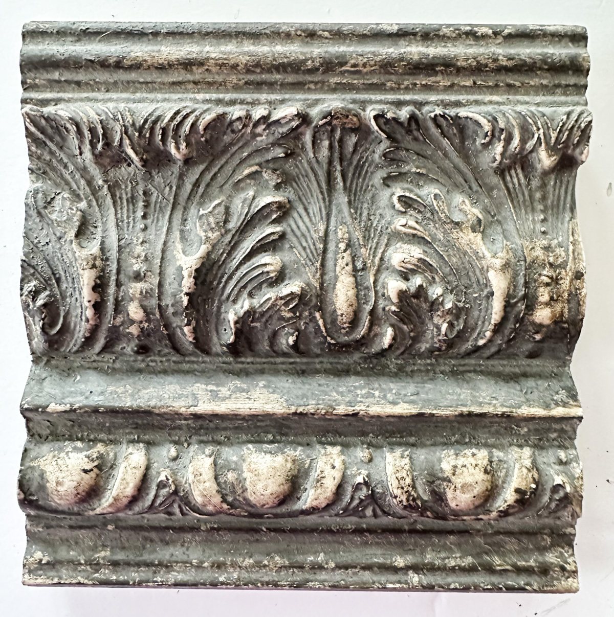 close up of decorative crown molding with an Amy Howard Home speciality finish to make it look old.