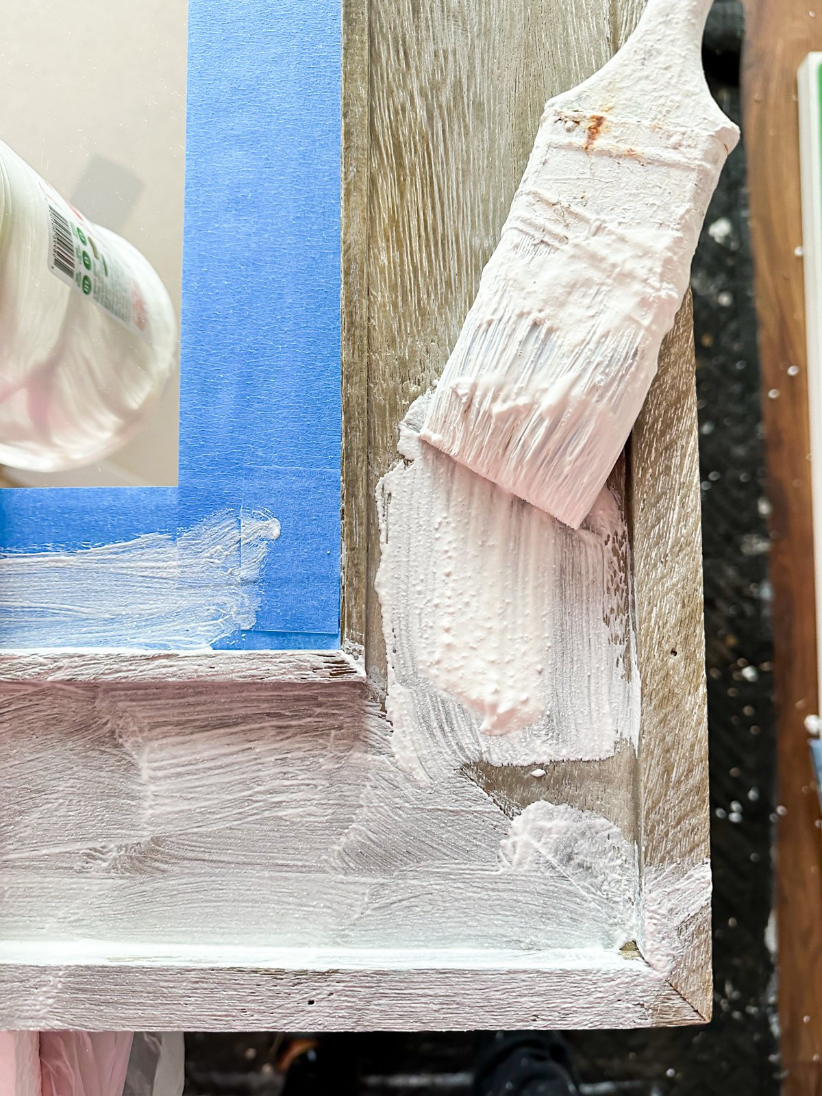 brushing on Vintage Plaster finish on raw wood mirror frame.