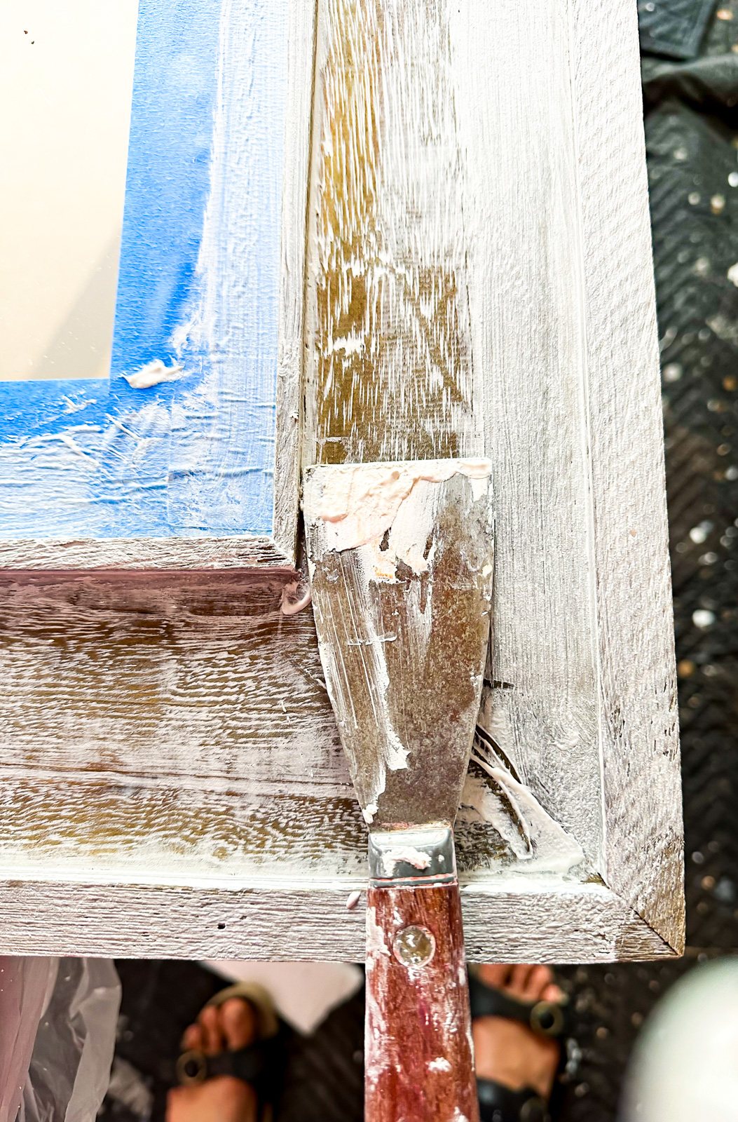 Applying Amy Howard Vintage plaster over a raw wood frame on a mirror.