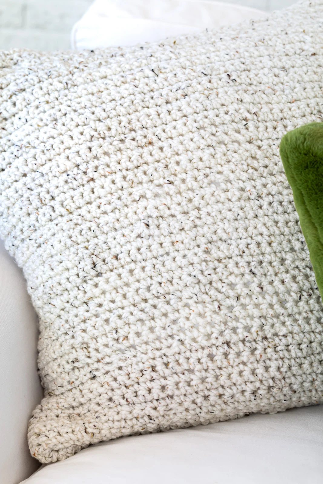 Close up the crocheted pillow cover on sofa.