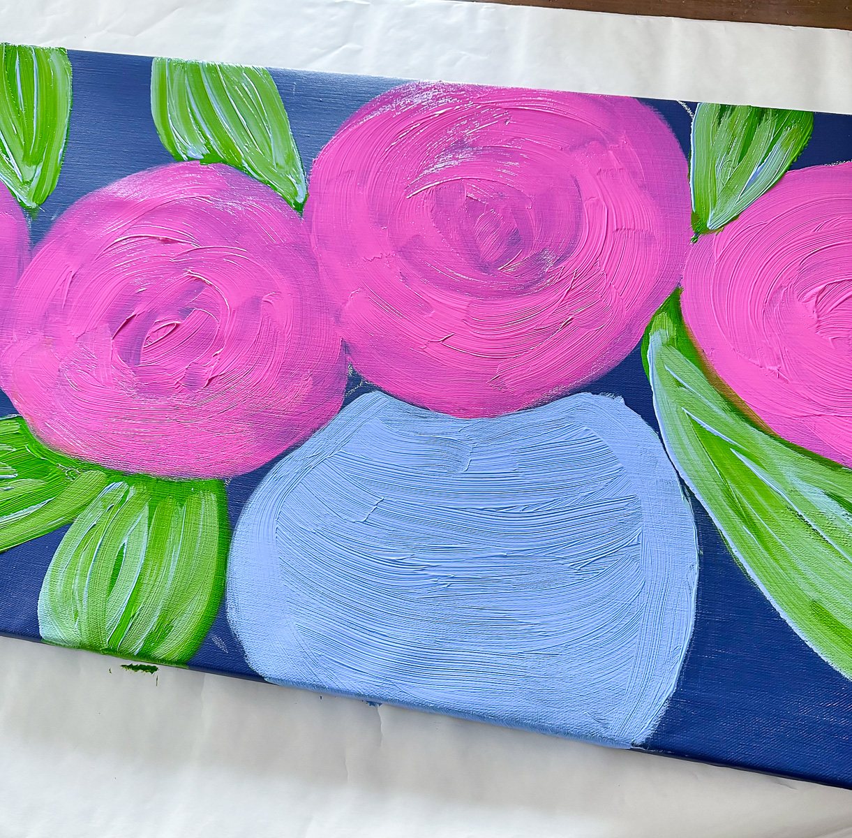 Step 2: Base color of a vase pink flowers and leaves on a art canvas showing the brush strokes.