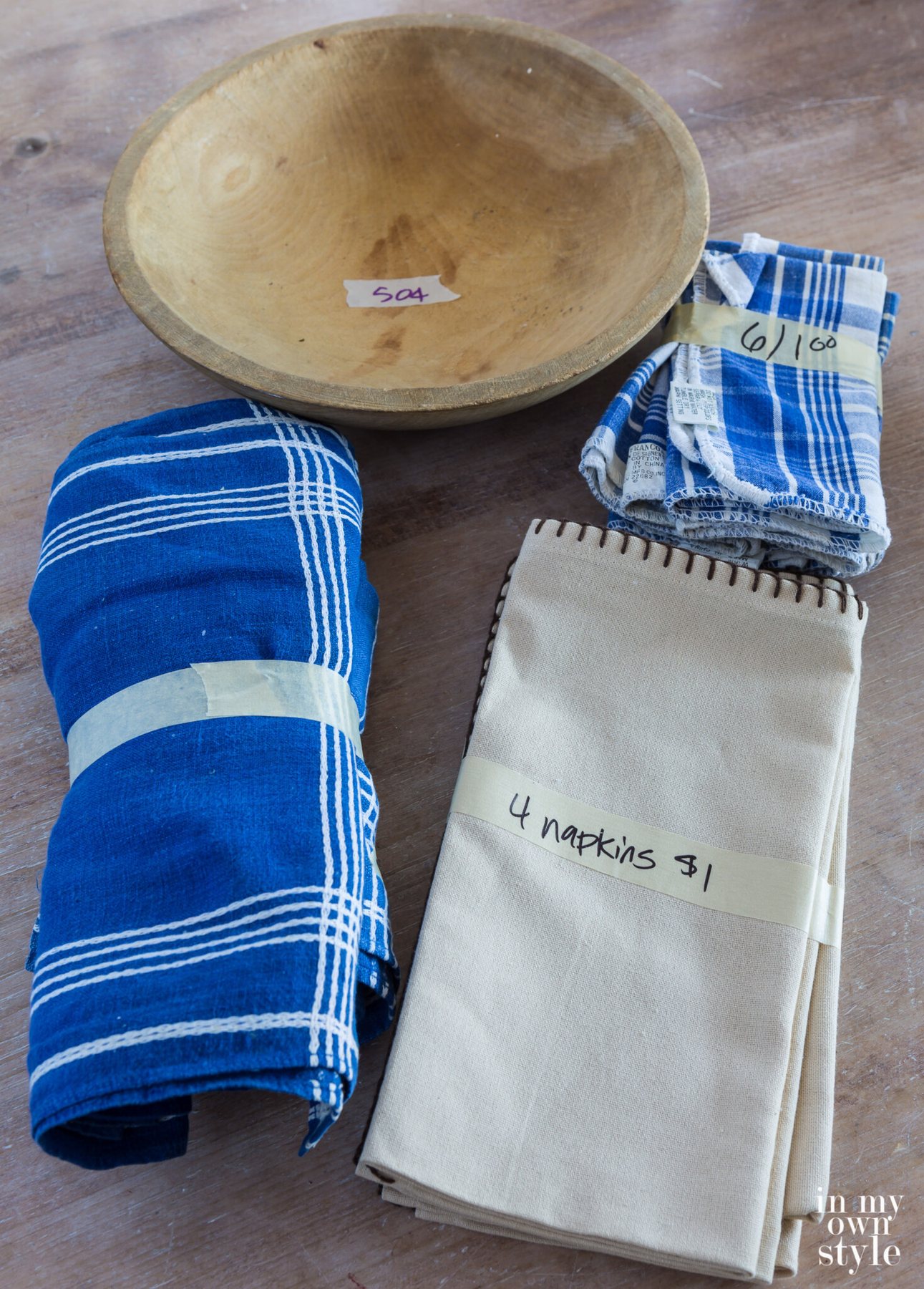 Church bazaar trash to treasure shop finds. Blue and white table linens and a wood bowl