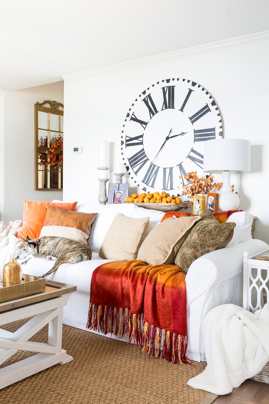 Bloggers Fall home tour living room decorated in fall colors of orange and brown with a navy accent.