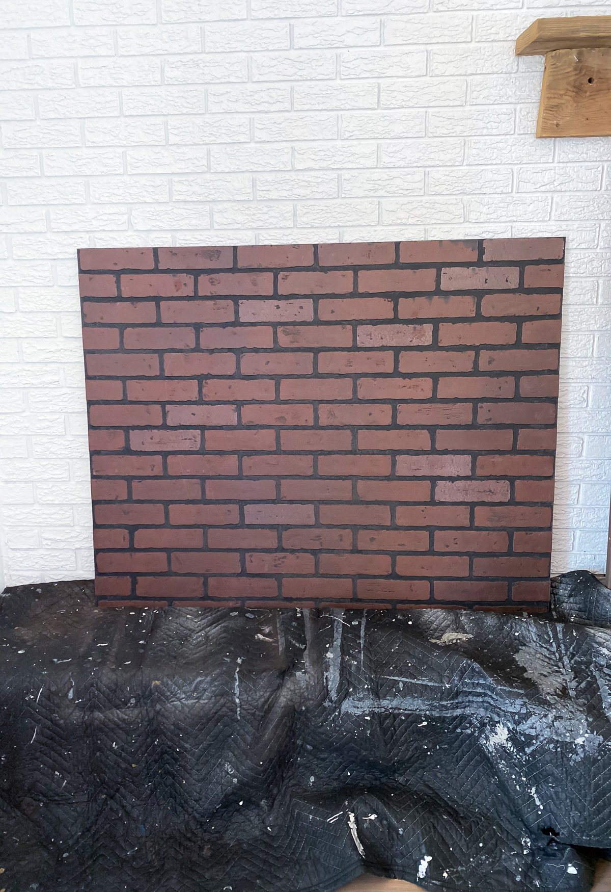 A faux brick panel from Lowes cut to size needed to cover an opening in a brick wall.