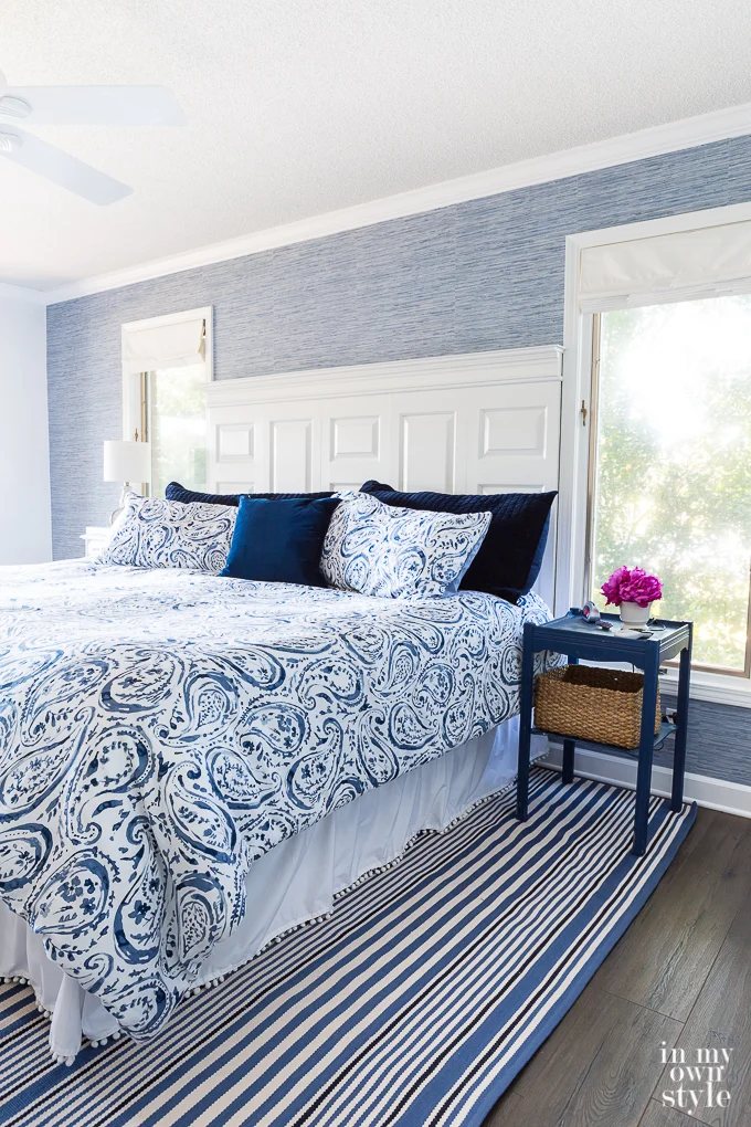 Blue grasscloth wallpaper used as a color accent on a wall in bedroom.