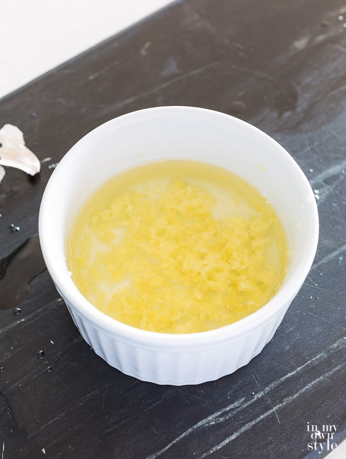 Minced garlic in a cup of oil.