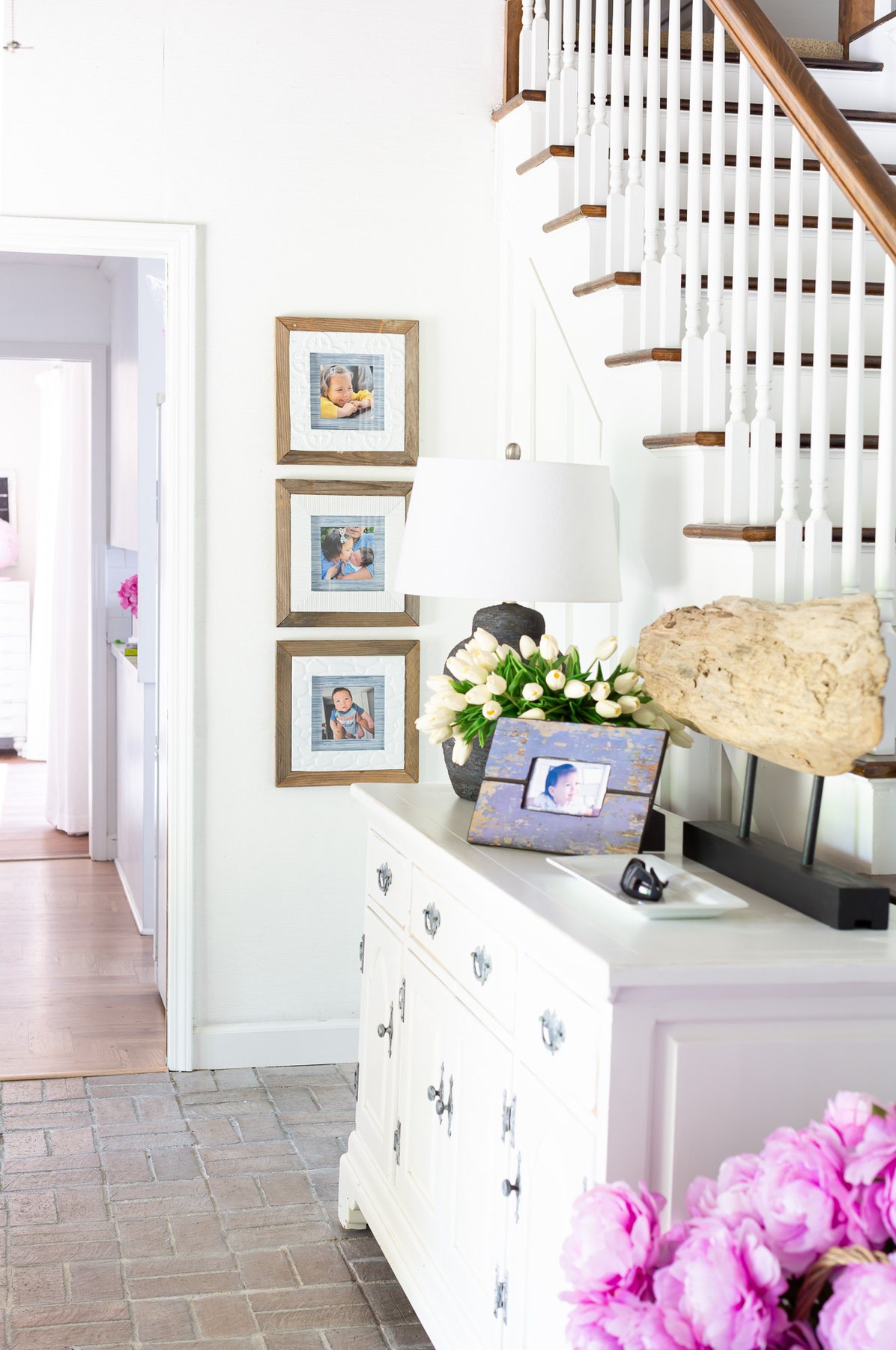 Display family pictures wall ideas in a foyer.
