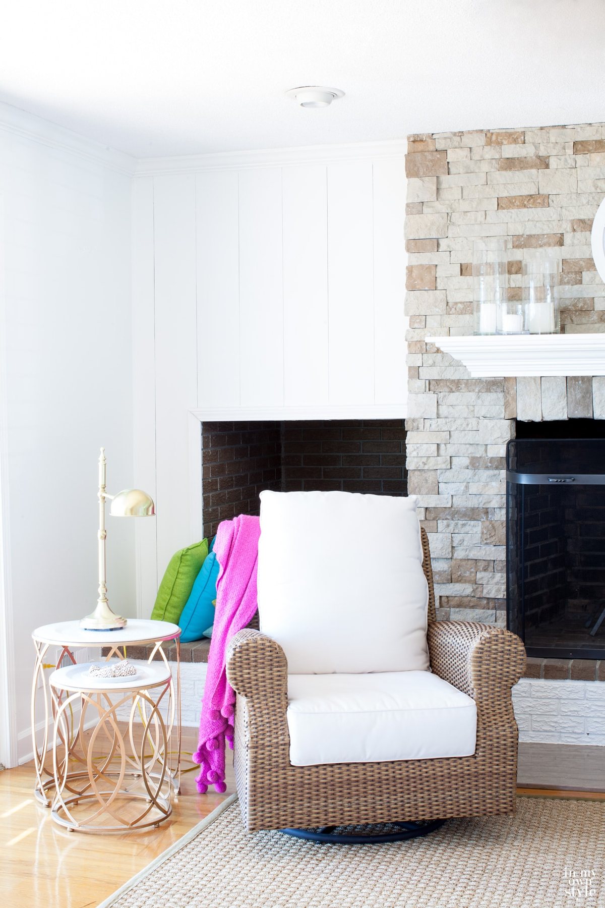Airstone fireplace in living room with glossy white trim and vertical panels to accent on either side