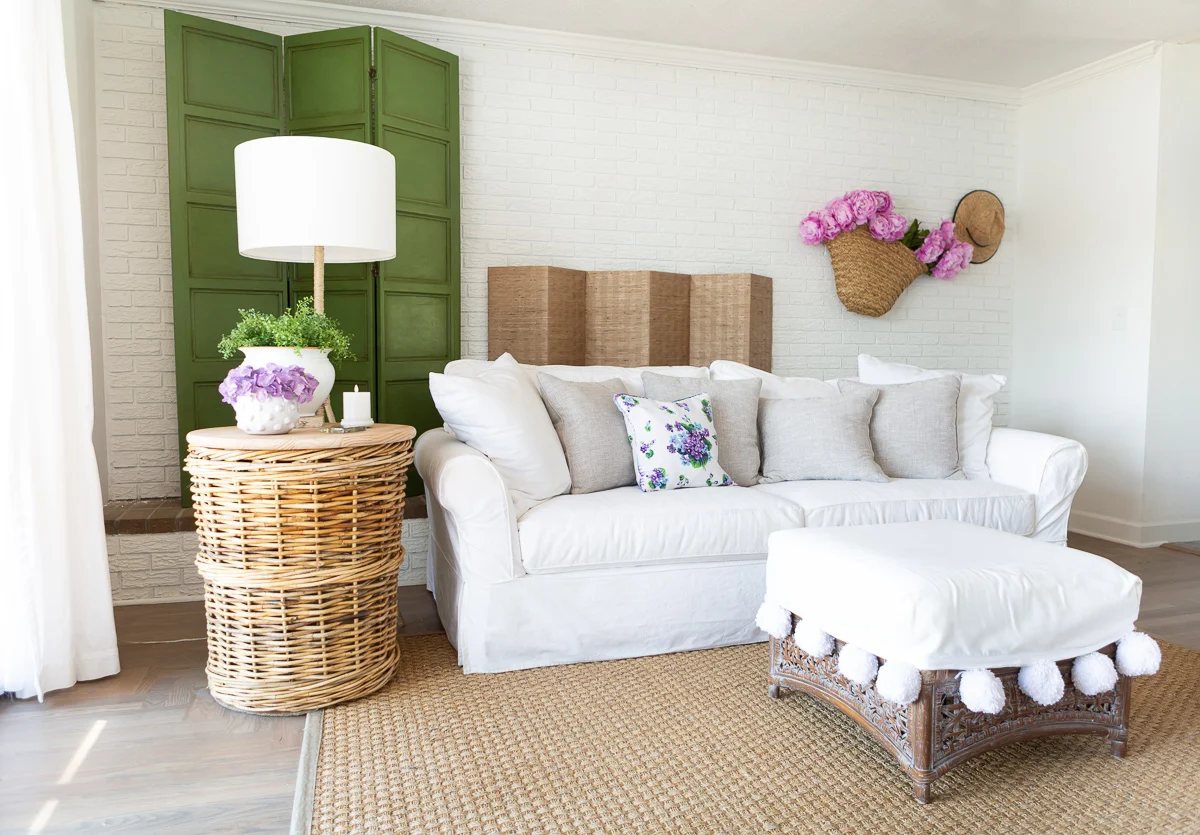 Summer decorated living room and fireplace screen cover on wall.