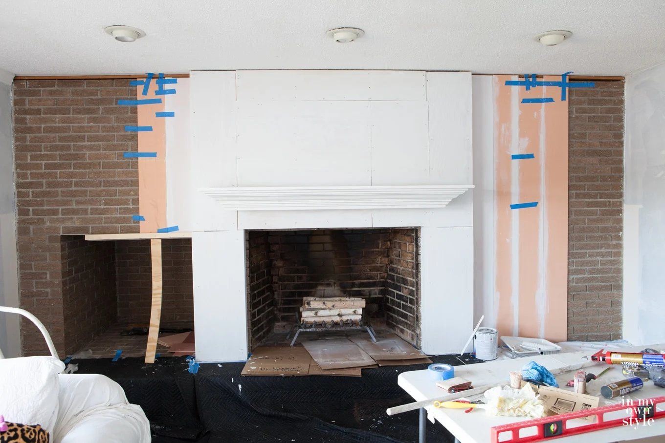 Brick fireplace wall makeover using vertical wood planking
