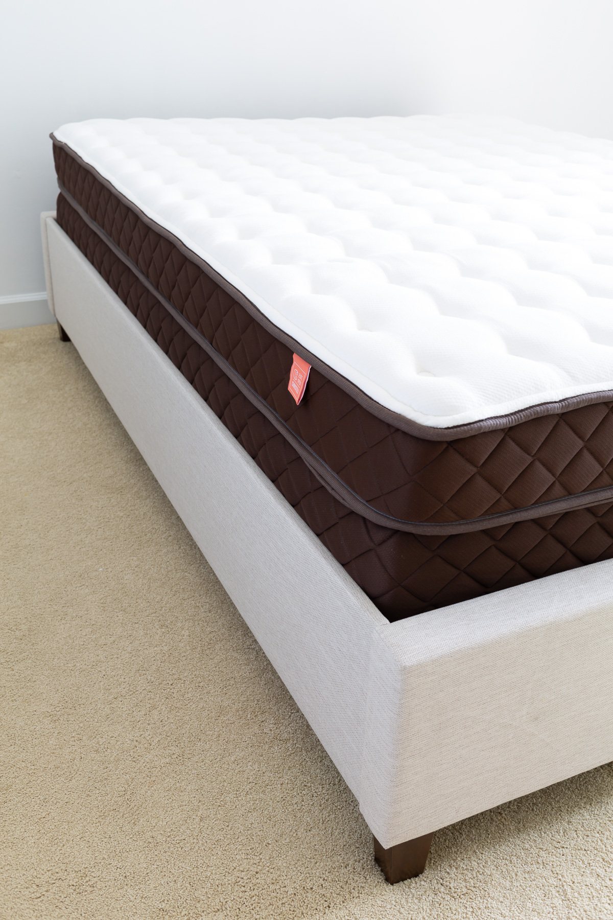 Looking at the corner of a Christeli Charleston mattress in Eastman platform bed frame.
