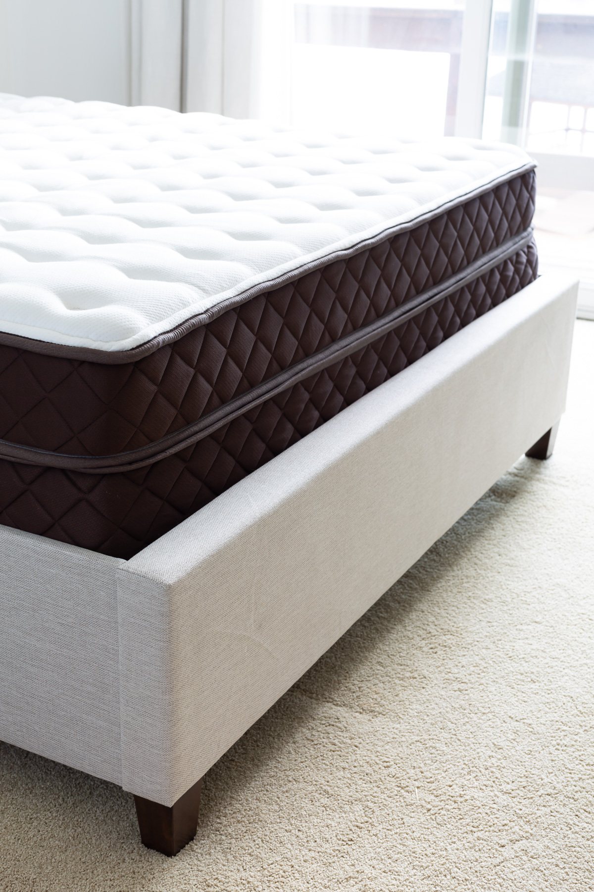 Christeli Charleston 14.5 mattress and base in an Eastman upholstered platform bed frame.