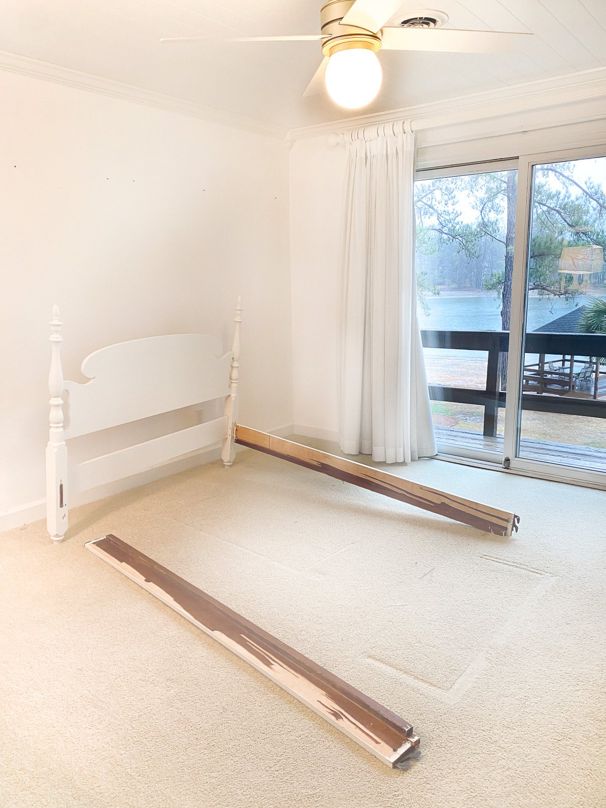 broken bed frame in empty bedroom