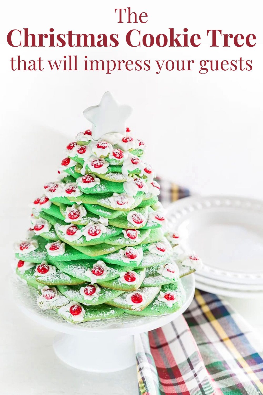 a Christmas cookie tree on a kitchen counter with a plaid dishcloth nearby. Text overlay says - The Christmas cookie tree that will impress your guests.
