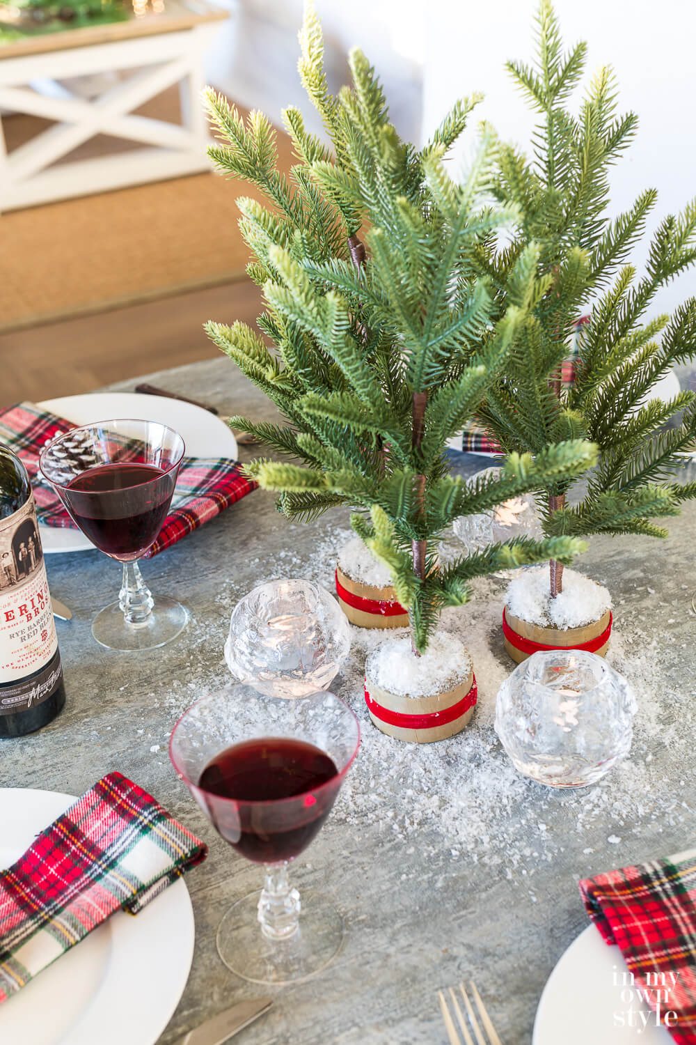 Kitchen table decorated for Christmas using red and plaid accents.