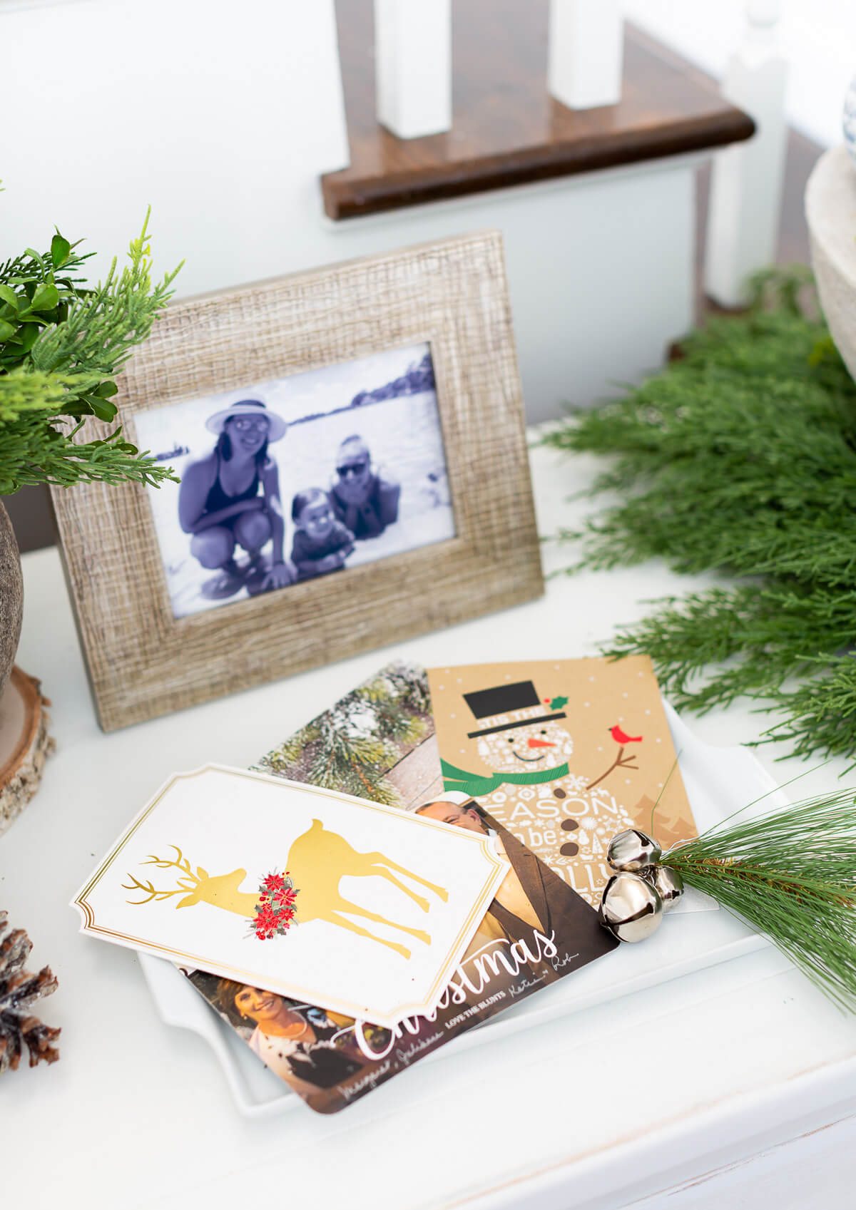 Christmas cards on tray on console table.
