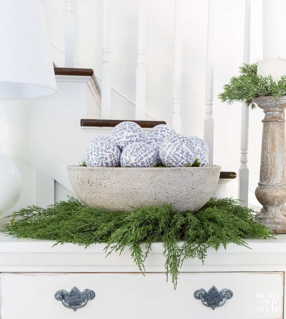 Low Zen bowl style planter on sideboard decorated with white and green for Christmas.