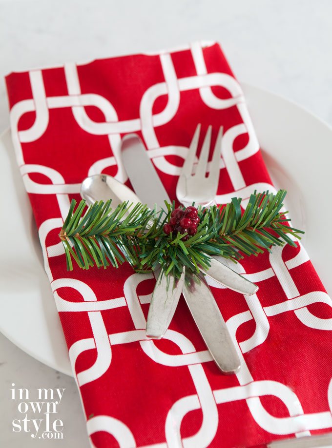 Christmas table setting idea using a garland tie and faux berries.