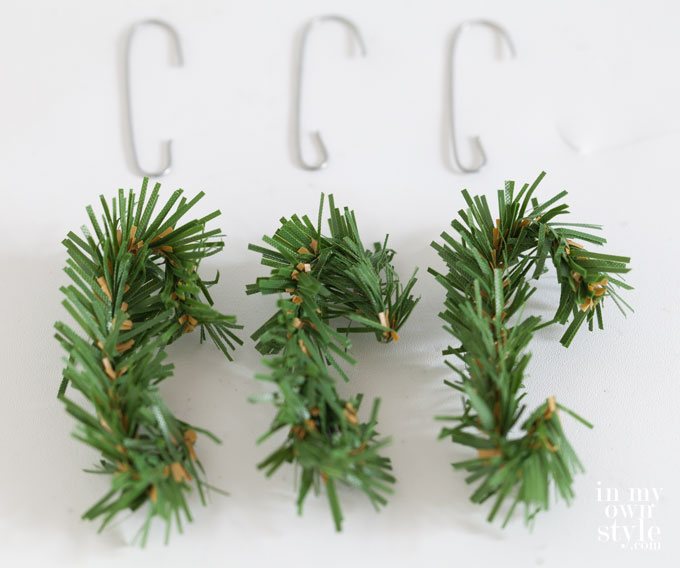Cut pieces of a garland tie made into Christmas ornament hooks.