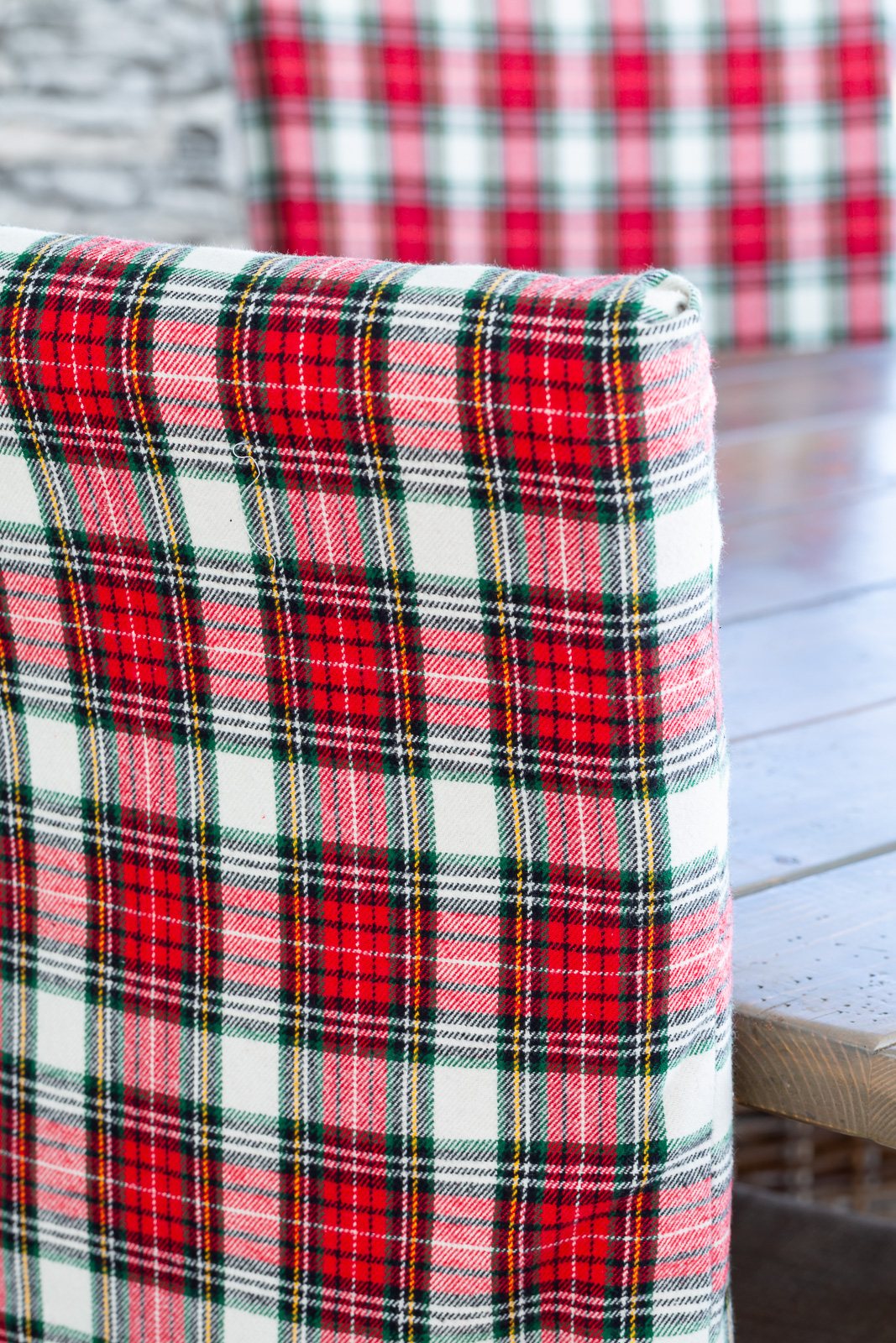 Close up of back of dining chair covered with classic Christmas plaid fabric.