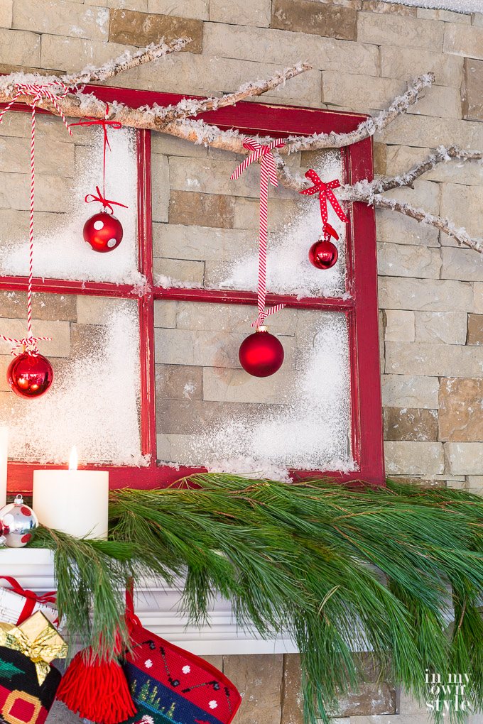 Christmas mantel decorating idea that uses an old window sash and tree branch.
