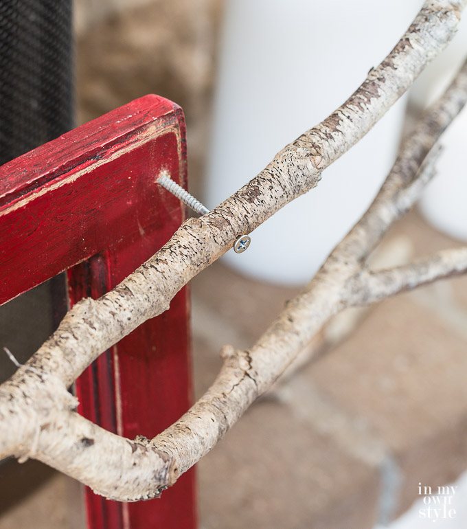 Christmas mantel decorating idea that uses a tree branch.
