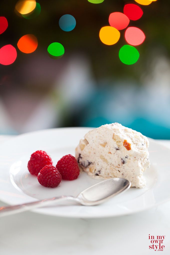 Frozen-semifreddo with 3 berries and spoon on a white plate.