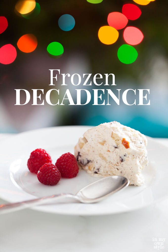 Semifreddo on white plate with raspberries and spoon. In the background are Christmas lights. Graphic overlays says Frozen Decadence