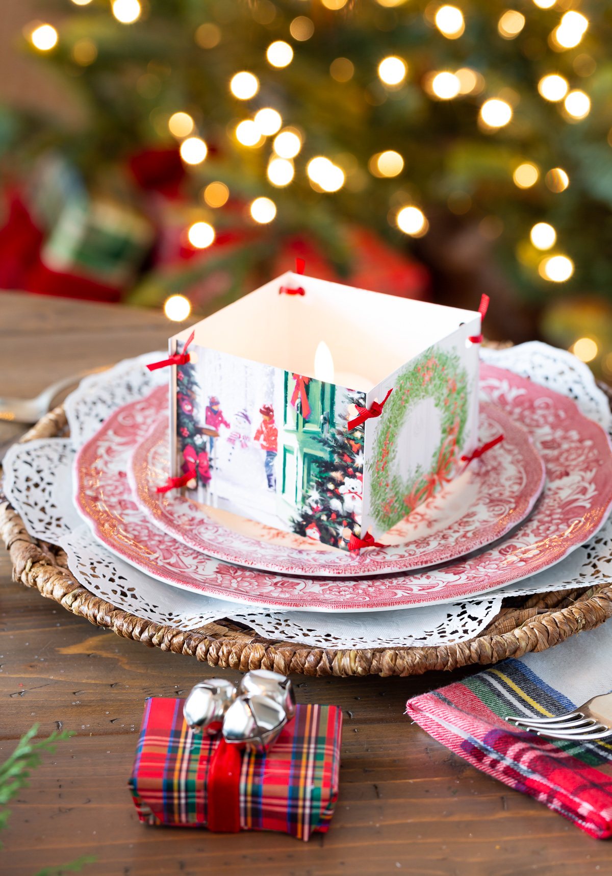 Christmas tablesetting idea using old Christmas cards to accent a small candle on a dinner plate.