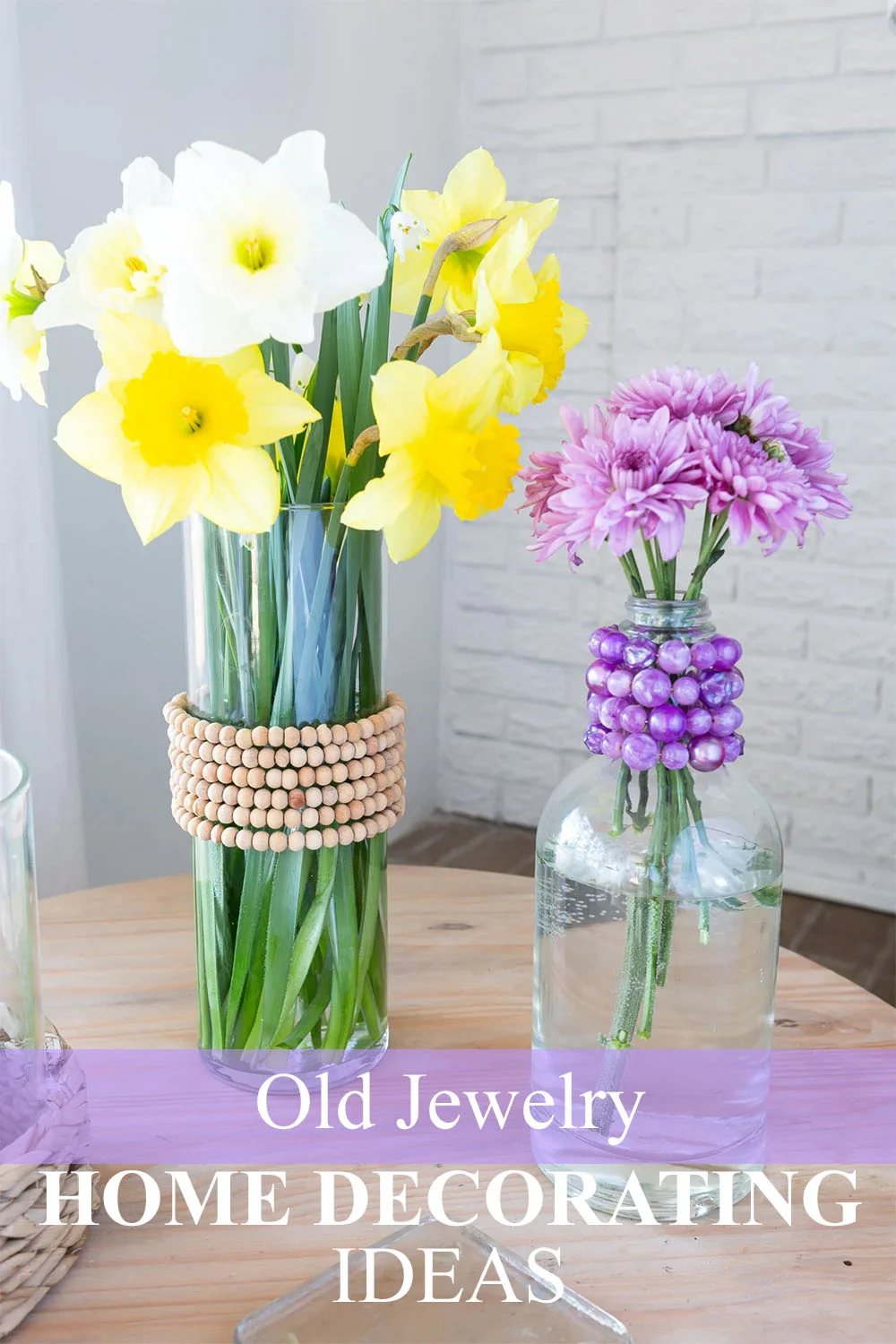 2 glass vases decorated with old jewelry.