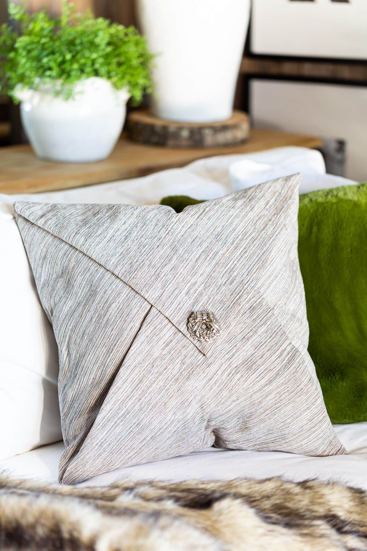 decorative pillow on sofa with pretty pin in center