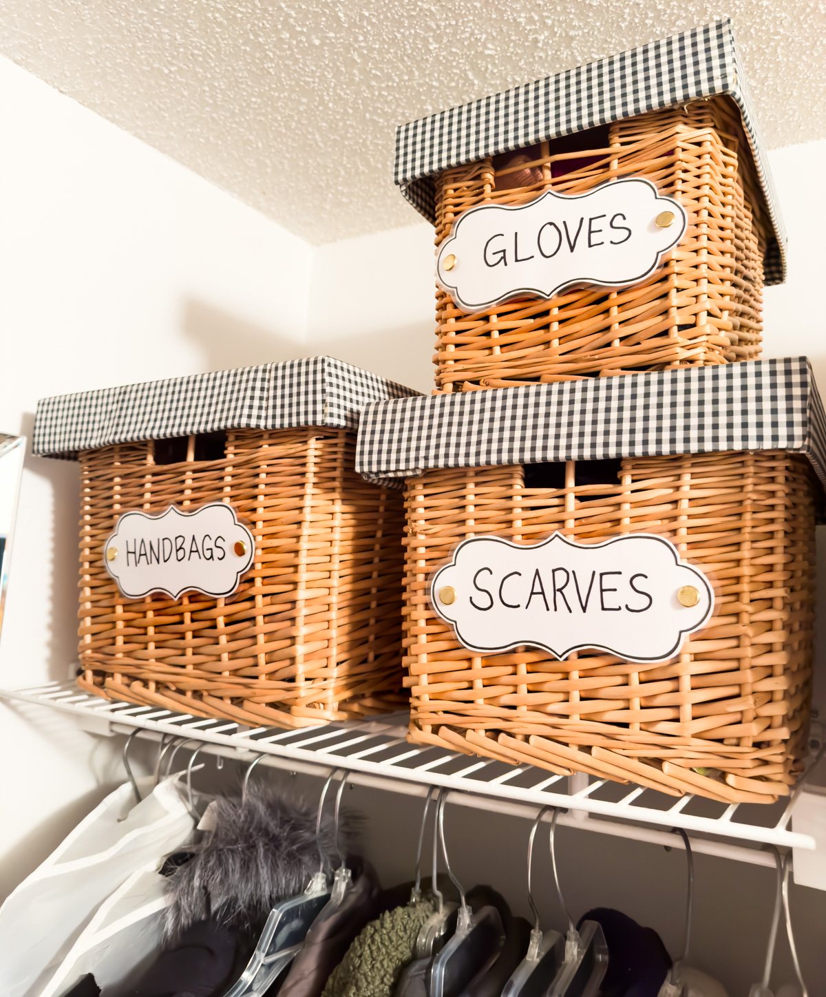 clothes closet organizing ideas using stackable baskets with DIY labels.