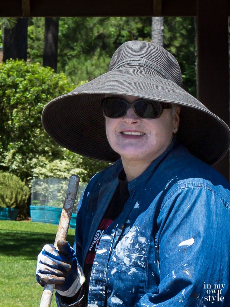 Closeup photo of Blogger Oducu wearing a large brim black hat to protect her Vitiligo from the sun.