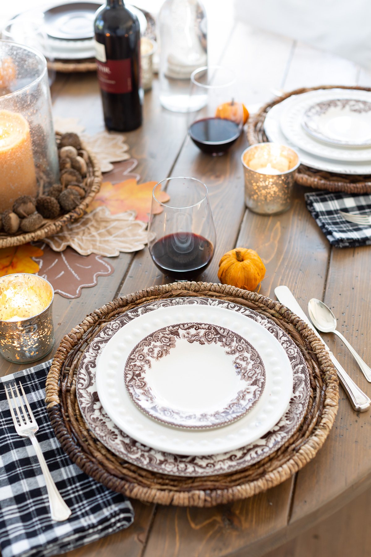 brown paper oak leaf place card on top of a dinner plate on a table