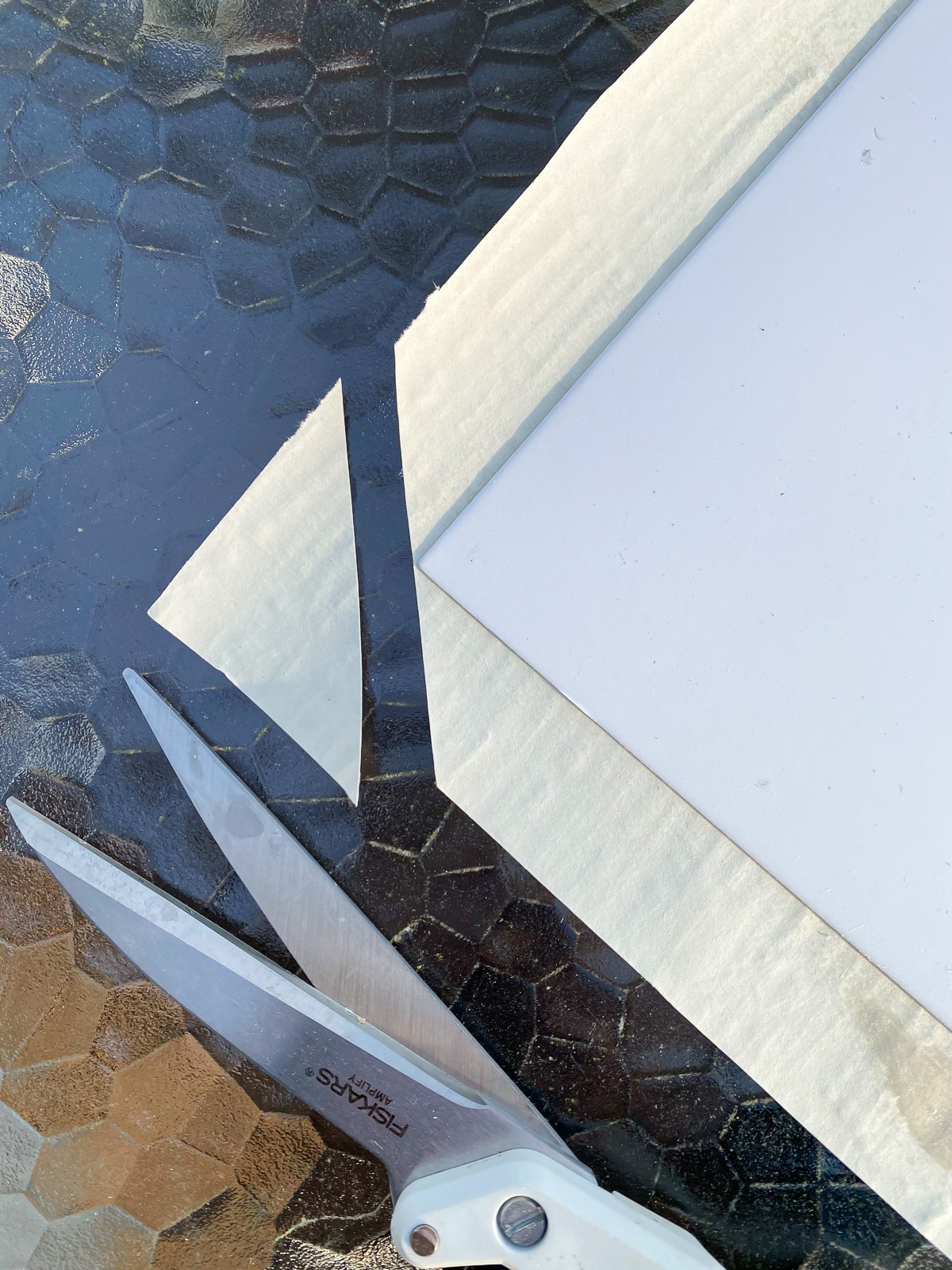 snipping corner of wallpaper to cover a picture frame mat