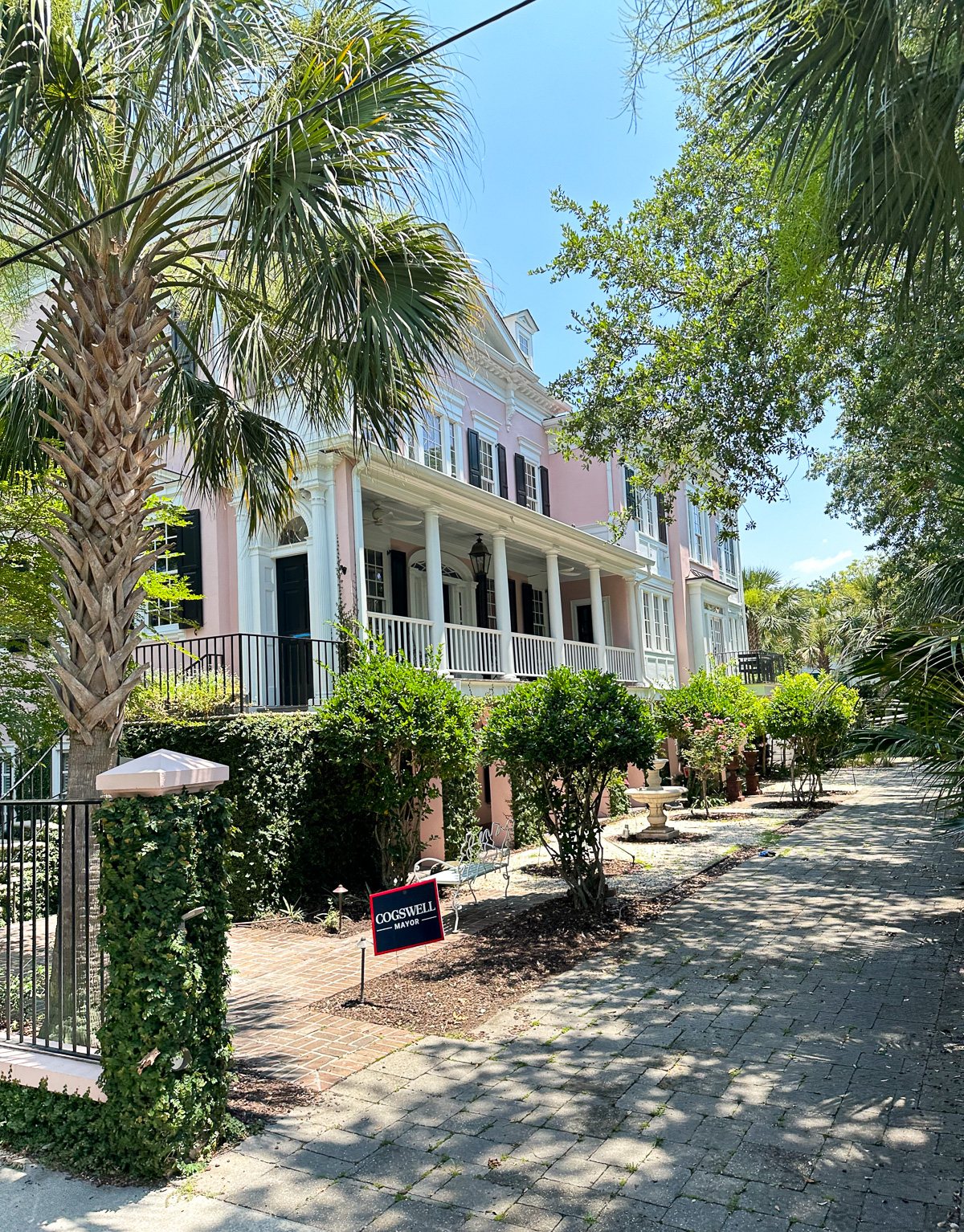 Pink Charleston home with a narrow lot where front of home is not facing the street.