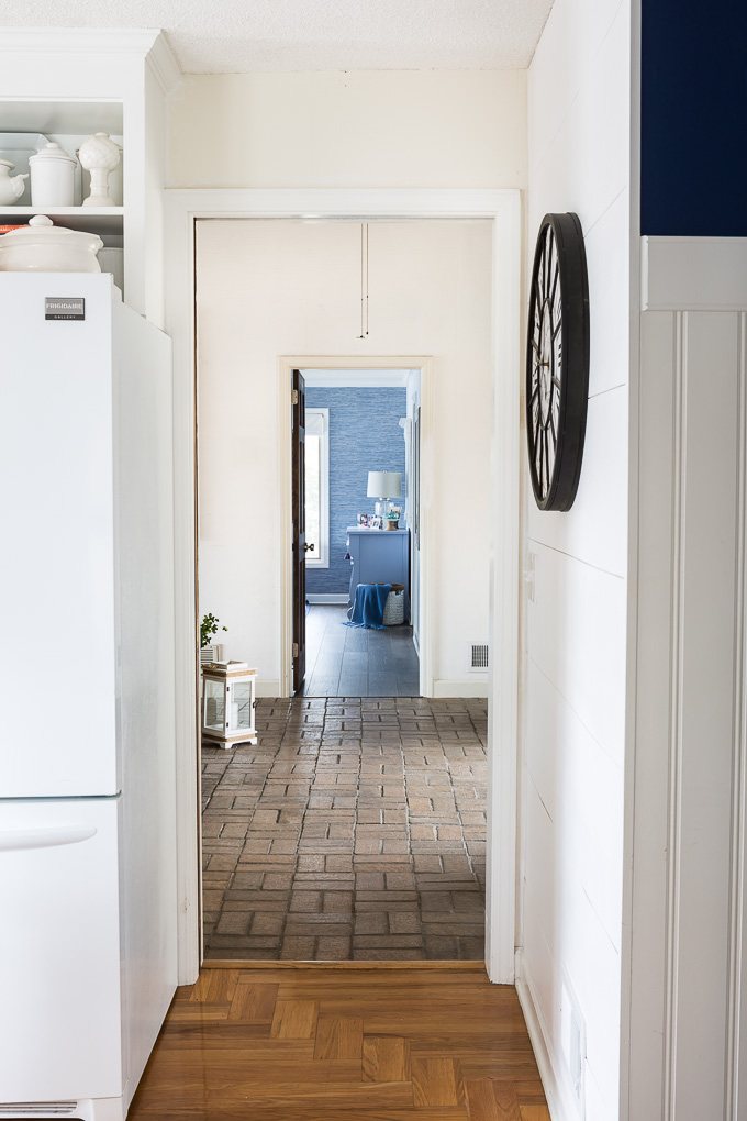 View of brick foyer floor from adjacent room in house