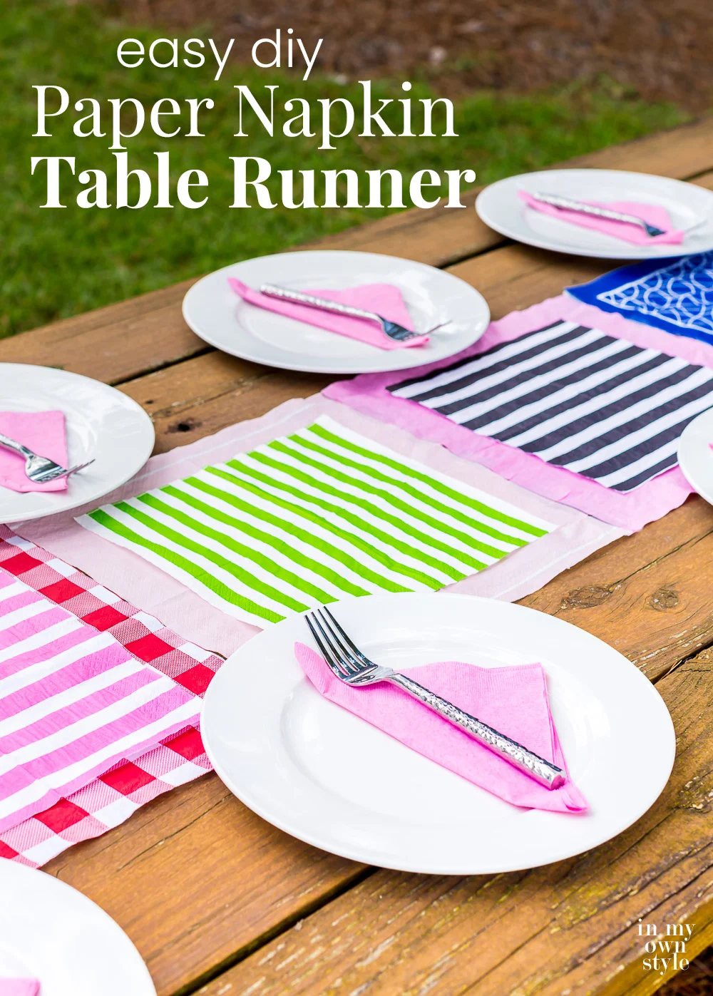 Outdoor picnic table with a colorful table runner in center made with paper napkins.