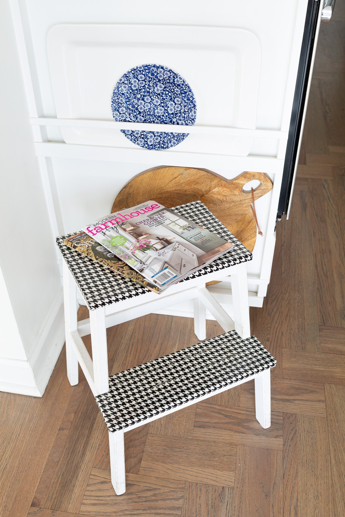 IKEA Bekvam Step Stool painted white with black and white houndstooth duck tape covering the steps.