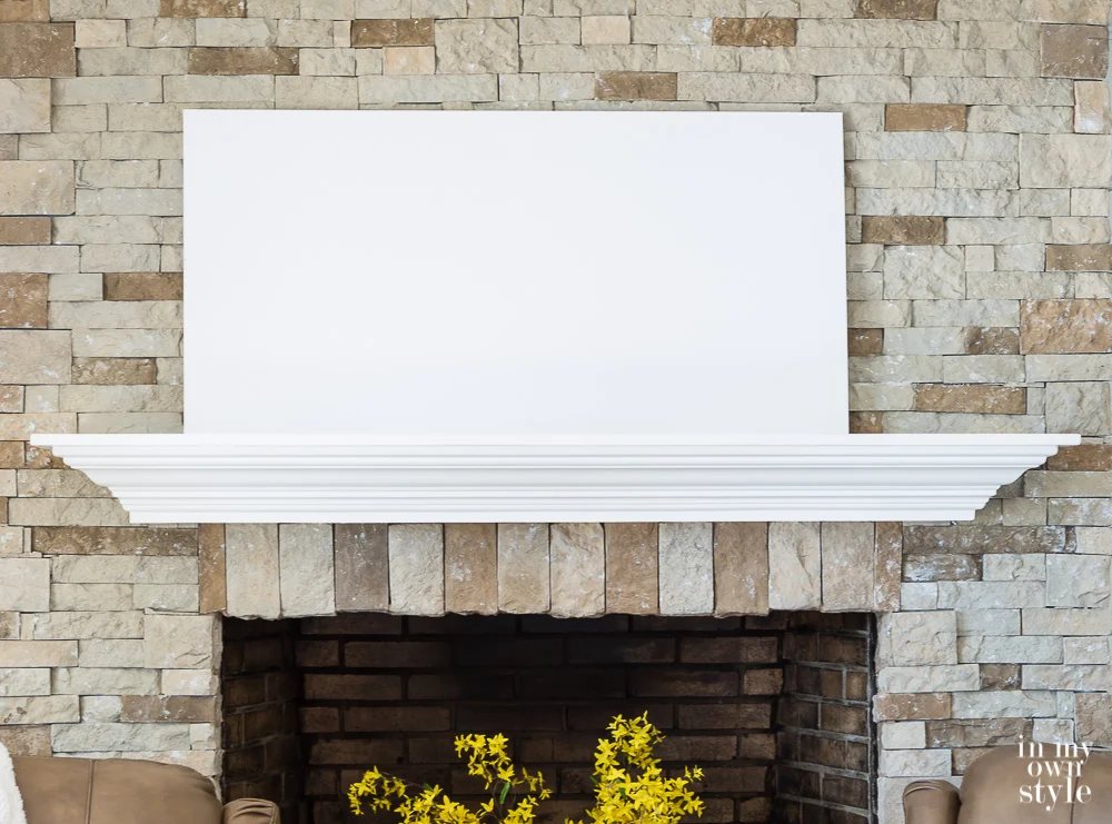 Start decorating a mantel by placing the largest item or layer first.
